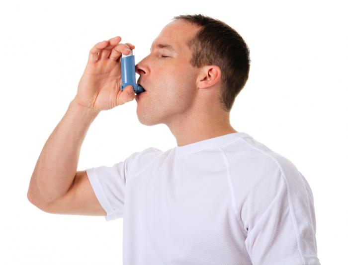 Младият човек използва астма помпа